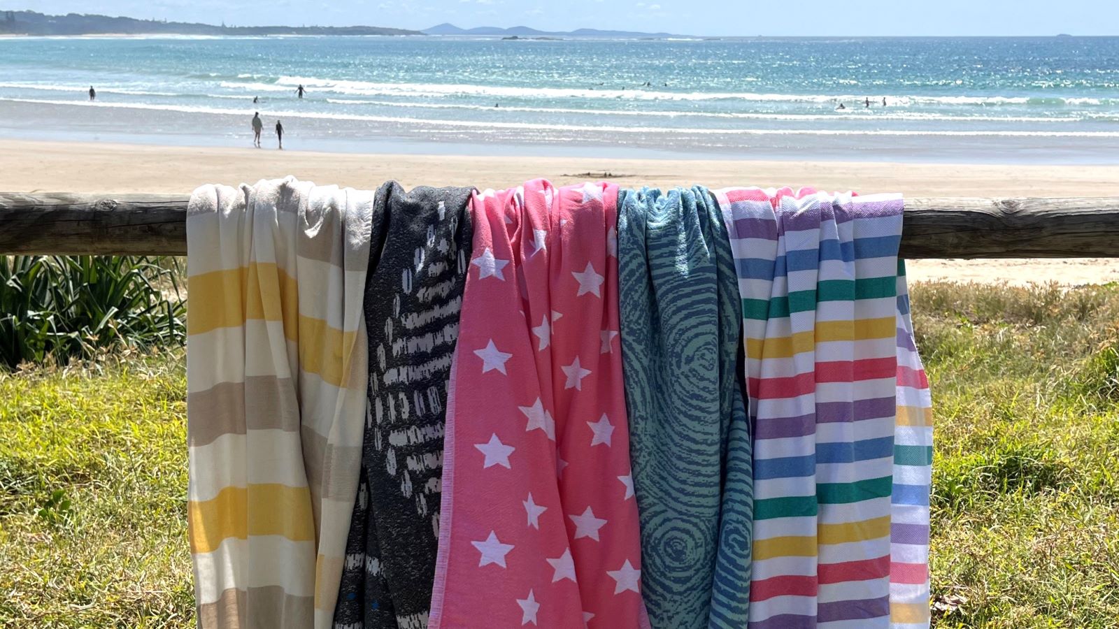5 turkish cotton beach towels over a fence at the beach
