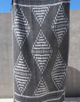 Black towel with large white diamond pattern shown full length