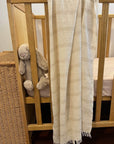Eden linen look cotton scarf displayed on a cot
