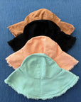 cotton bucket hats in black, mint, salmon and clay colours. 