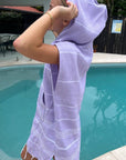 girl wearing lilac Classic hoodie by a pool